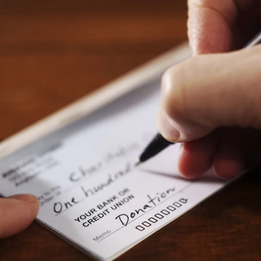 Writing a donation check to a charitable organisation