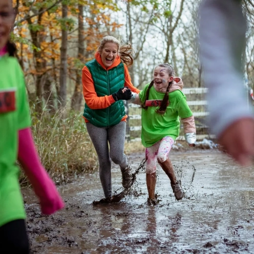 A girl in the sports team is given a helping hand from her coach