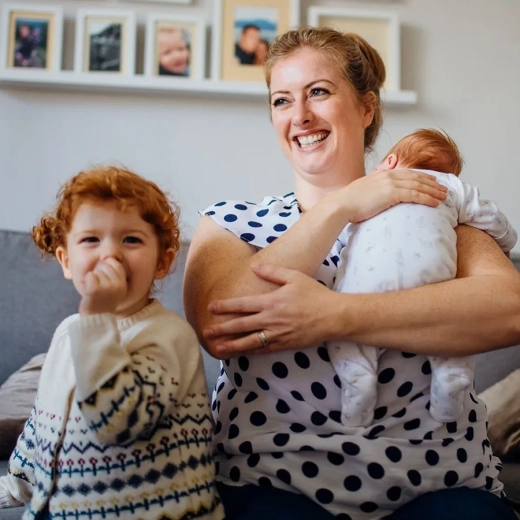 Mother with her two children in the living room of their home