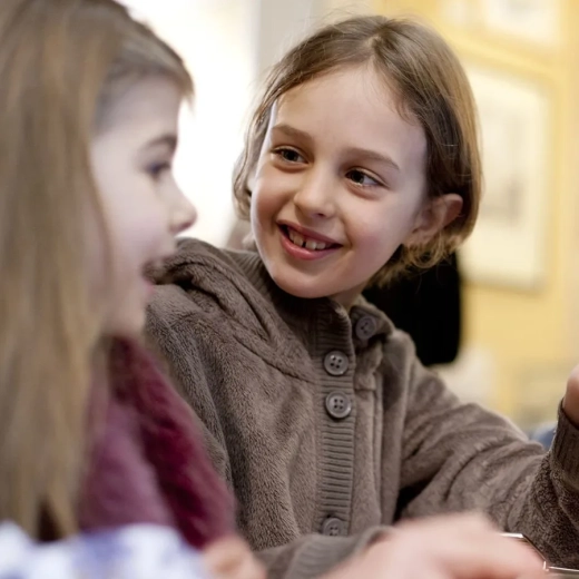 Two young girls are using a touch screen visual aid