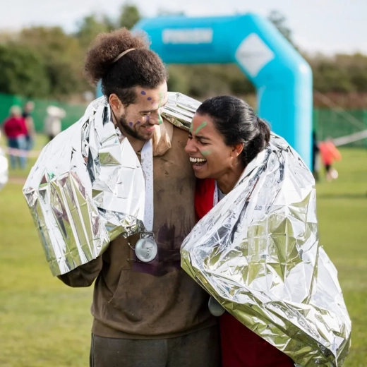Couple laughing together after charity event, cheerful, achievement, togetherness